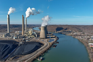 Power Plant with Blue Sky in Bend of Green River and Pile of Black Coal