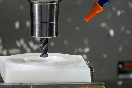 The  CNC milling machine cutting the nylon 6 material part with flat end mill tool.