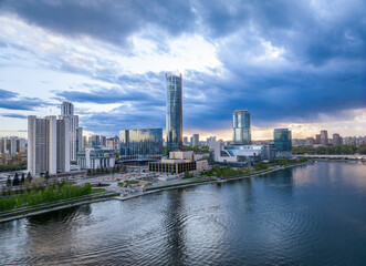 Fototapeta premium Yekaterinburg city and pond aerial panoramic view at summer sunset.