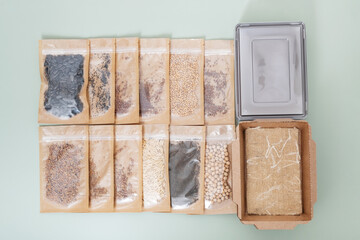 Set for growing sprouts from seeds. Seeds, linen mats, boxes and lids flat lay, top view