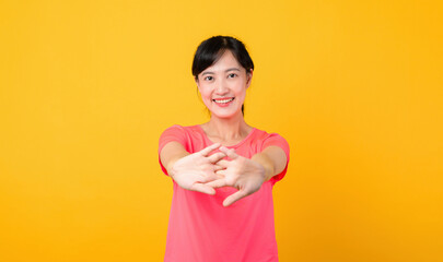 Portrait beautiful young asian sports fitness woman happy smile wearing pink sportswear posing exercise training workout isolated on yellow studio background. wellbeing and healthy lifestyle concept.