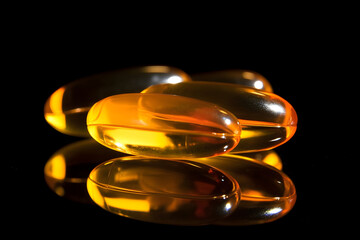  Close up of Omega 3 gel capsule on a reflective black background 