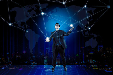 Fototapeta na wymiar Businessman on blurred night cityscape background using flying network connection