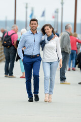 young couple walking on pier