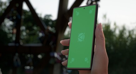 CU 20s Caucasian female holding a phone in a right hand, vertical orientation