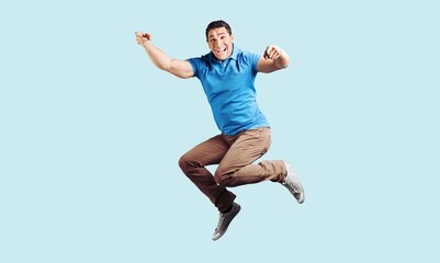 Fototapeta premium Young fun person jump on background