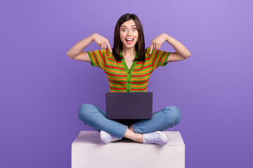 Fototapeta Photo of cute impressed woman dressed striped cardigan pointing two fingers modern device isolated violet color background obraz