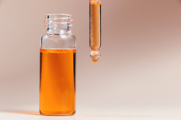 Pipette with a glass bottle on a light background.