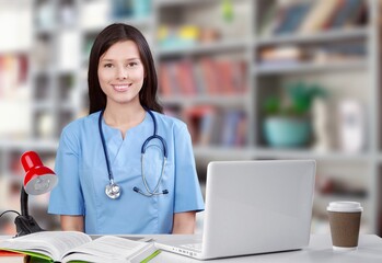 Young doctor beautiful woman working with a laptop