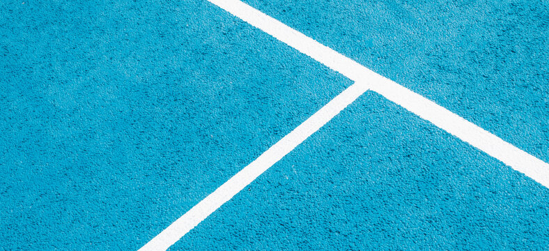 Sport field court background. Light blue rubberized and granulated ground surface with white lines. Top view