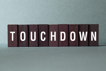 Touchdown - word concept on building blocks, text