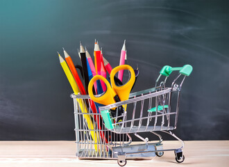 Banner of Shopping cart with school supply in front of blackboard Back to school concept. Generative AI