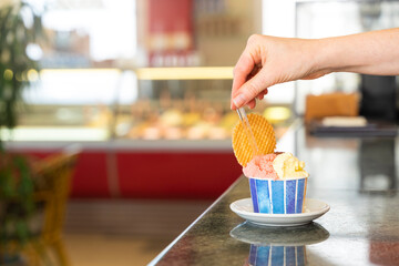 A tub of ice cream in two flavors and a cookie