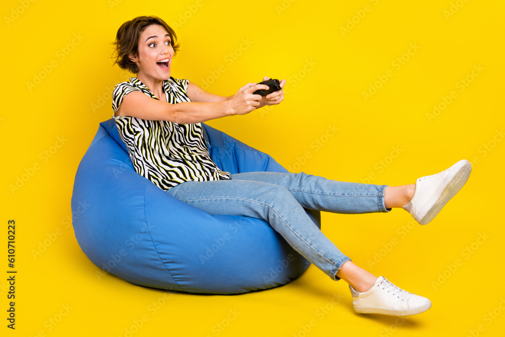 Wall mural full length photo of pretty excited woman dressed zebra striped shirt enjoying playstation empty spa