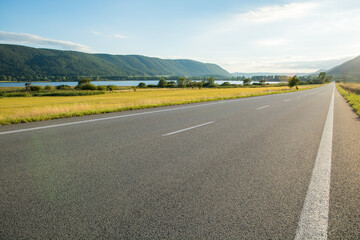 Fototapeta premium straight empty road at sunset