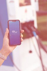 alternative energy concept.Close up of the Hybrid car electric charger station with power supply plugged into an electric car being charged.EV station sites.blur focus.noise.