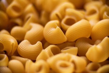 dry  raw Italian pasta pipe rigate Diet and food concept Uncooked Macaroni background texture Stack closeup  top view.