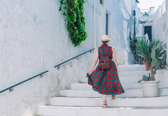 A young girl walks the streets of the historic white town of Ostuni in the Italian region of Puglia
