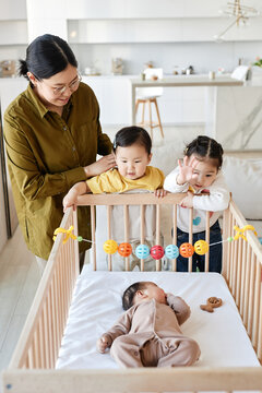 Asian young woman caring about her three children at home