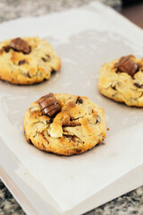 Stock image of three cookies with chocolate on top.
