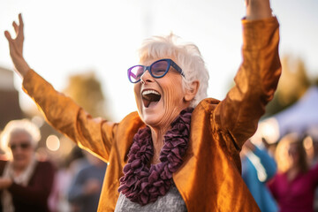 A joyful senior woman dancing with her arms in the air during a lively outdoor concert, elderly happy people, old age, bokeh Generative AI