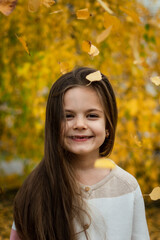 portrait of a girl with dark hair in an autumn park with yellow leaves