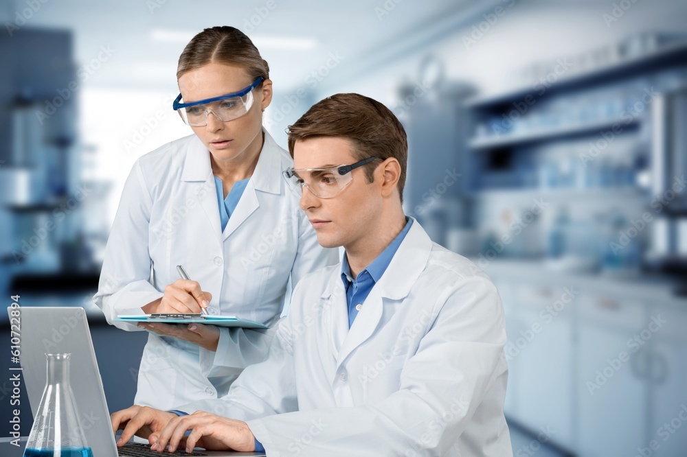 Poster two smart scientists using computer in medical laboratory