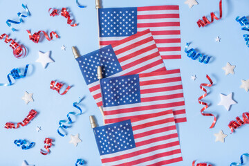 Obraz premium USA Independence day concept. USA flags and Red and blue spirals and white stars top view, flat lay on blue background