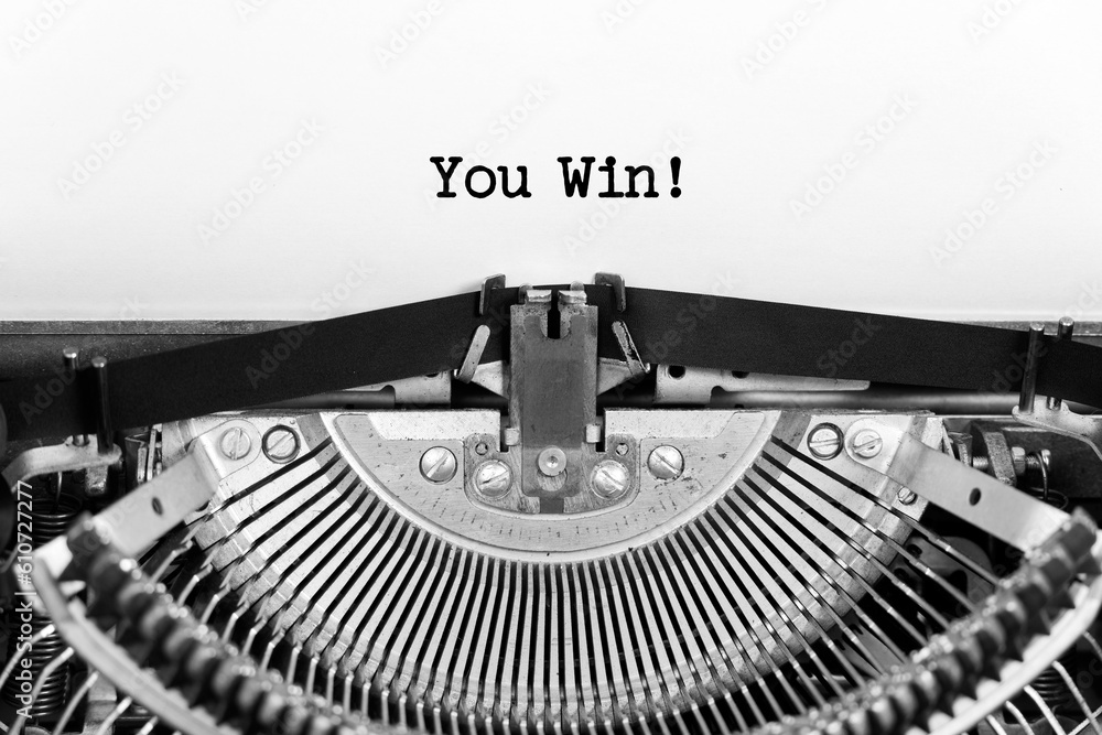 Fototapete you win phrase closeup being typing and centered on a sheet of paper on old vintage typewriter mecha