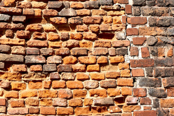 Old brick wall background, brick wall texture, structure. old broken brick, cement joints, close-up. crumbling from old age.