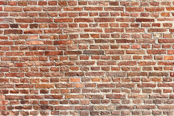 Fototapeta premium Old brick wall background, brick wall texture, structure. old broken brick, cement joints, close-up. crumbling from old age.