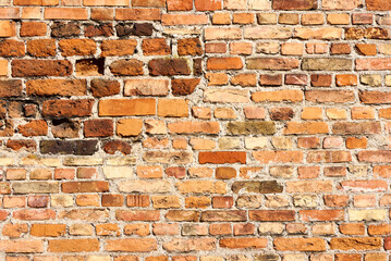 Old brick wall background, brick wall texture, structure. old broken brick, cement joints, close-up. crumbling from old age.