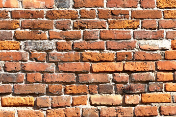 Old brick wall background, brick wall texture, structure. old broken brick, cement joints, close-up. crumbling from old age.