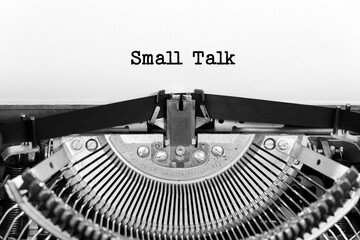 Small Talk phrase close up being typing and centered on a sheet of paper on old vintage typewriter mechanical