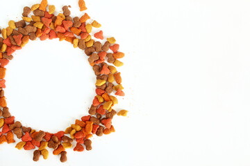 multicolored dried animal or pet food as pet food or health background texture,round frame on white...
