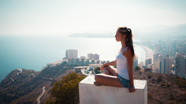 Summer vacation travel Spain photo - girl on the top of the mountain near Benidorm watching on the beach
