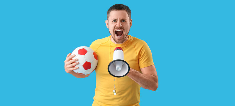 Male coach with soccer ball and megaphone on blue background