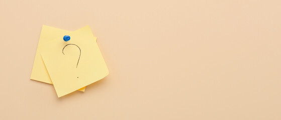 Sticky papers with question mark on beige background with space for text