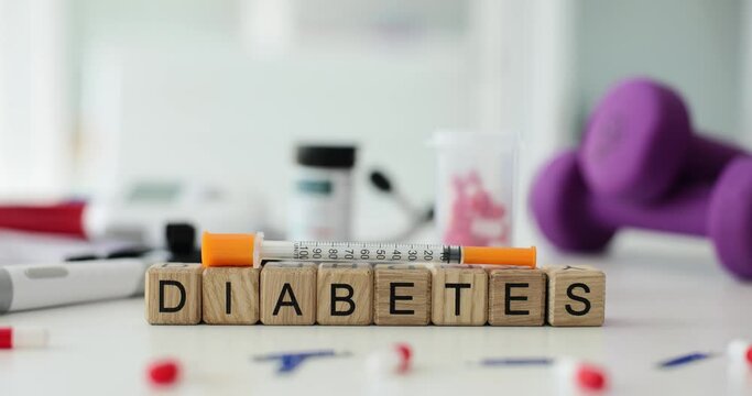 Word diabetes on cubes with syringe and pills on table. Insulin injection and blood sugar control