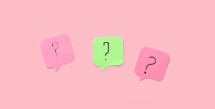 Sticky papers with question marks on pink background - Powered by Adobe