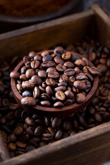 Roasted coffee beans in a rustic wooden bowl