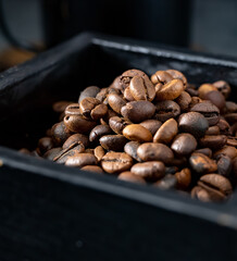 Roasted coffee beans in a black wooden box
