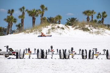 line of tires, in front of a sand dune 