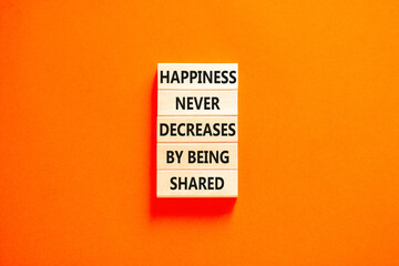 Naklejka premium Happiness symbol. Concept words Happiness never decreases by being shared on wooden block. Beautiful orange table orange background. Motivational Happiness concept. Copy space.