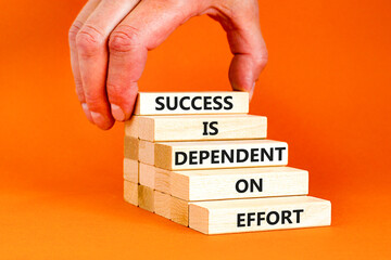 Success and effort symbol. Concept words Success is dependent on effort on wooden block. Beautiful orange table orange background. Businessman hand. Business success and effort concept. Copy space.