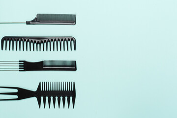 Professional combs and hairdresser tools on color background, top view