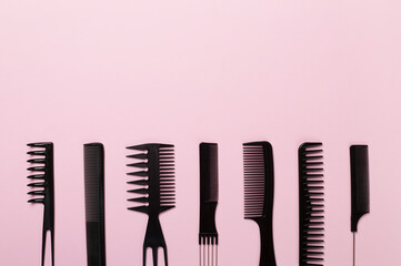 Professional combs and hairdresser tools on color background, top view