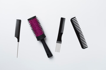 Professional combs and hairdresser tools on color background, top view