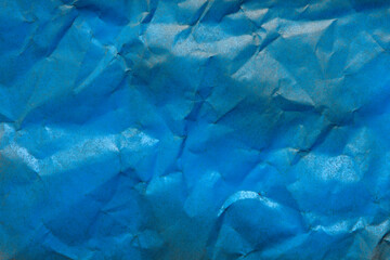 crumpled krantf paper painted blue with spray paint