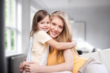 Happy child hugs young mother